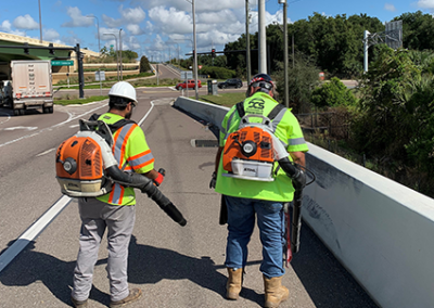 DCS employees cleaning roadside